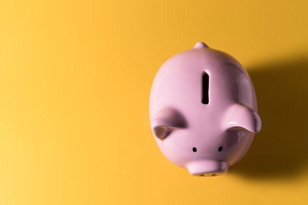 Piggy bank on yellow background for economy, saving money wealth and financial concept