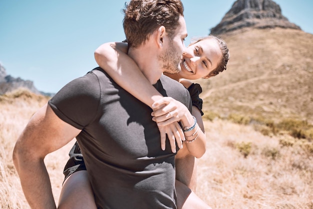 Piggyback happy and in love couple having fun being active and enjoying quality time together outdoors Cute sweet and loving boyfriend and girlfriend bonding on an adventurous and cheerful date