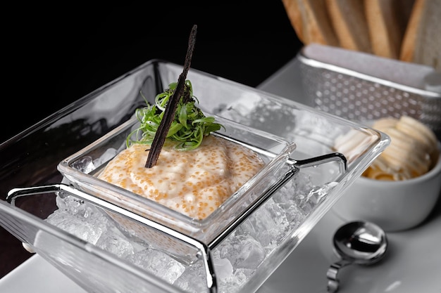 Pike caviar in ice with toas selective focus