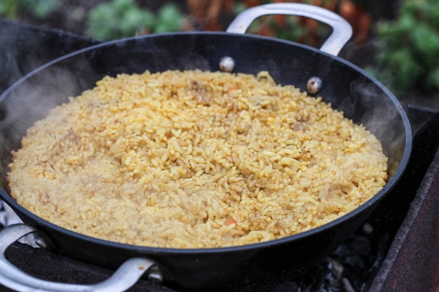 Pilaf is cooked on hot coals