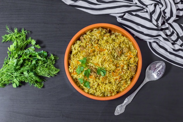 Pilaf with beef, carrots, onions, garlic, pepper and cumin. A traditional dish of Asian cuisine. Selective focus