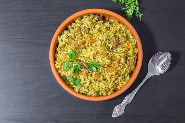 Pilaf with beef, carrots, onions, garlic, pepper and cumin. A traditional dish of Asian cuisine.