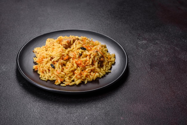 Pilaf with chicken Traditional oriental hot dish of boiled rice chicken meat vegetables and spices in a plate