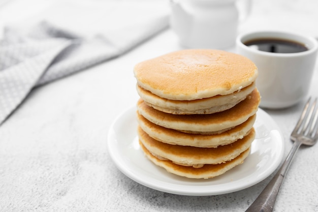 Pile of american clasic pancakes breakfast or snack, isolated on white