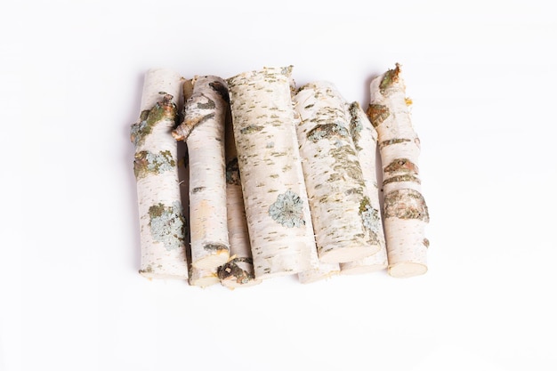 A pile of birch firewood on white background