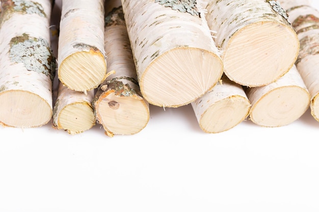 A pile of birch firewood on white background