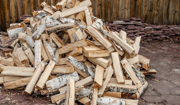 Photo a pile of birch firewood in the yard.