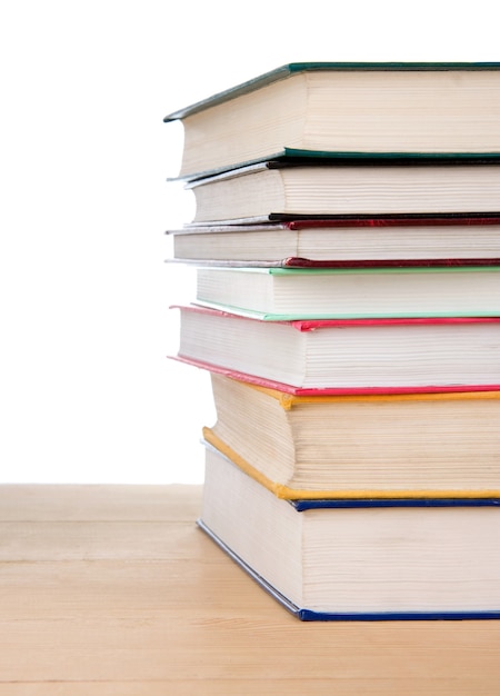 Pile of books isolated at wood on white