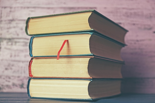 Pile of books on wooden background