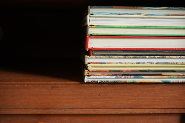 pile of books in wooden cabinet with empty space room for text