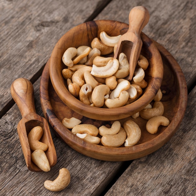 Pile of bowls filled with healthy raw cashew nuts