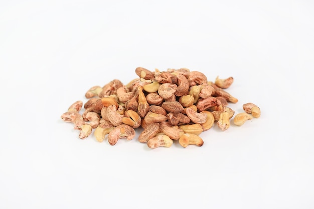 Pile of Cashew nuts with shell isolated on white background