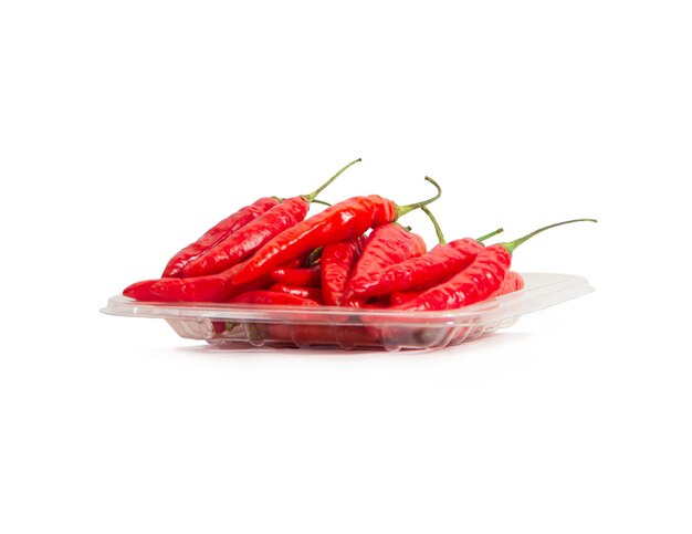 pile of chilies on a transparent plate on isolated white background