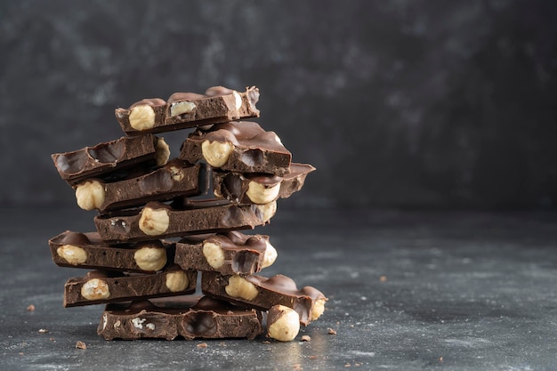 Pile chocolate with nuts on the gray background