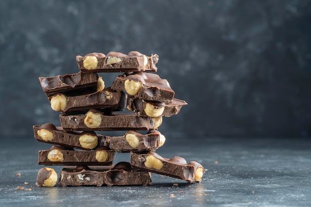 Pile chocolate with nuts on the gray background