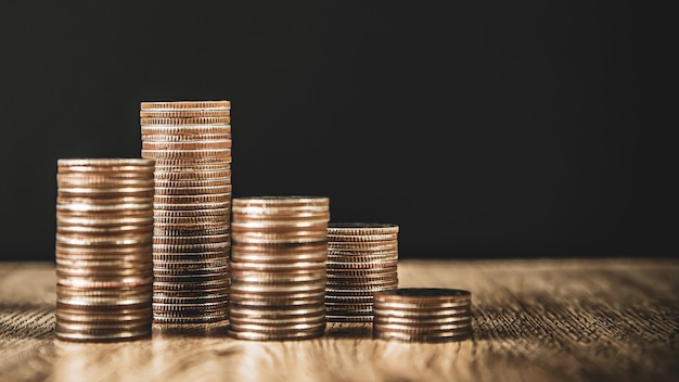 Pile of coins are stacked in a graph shape for money saving ideas.