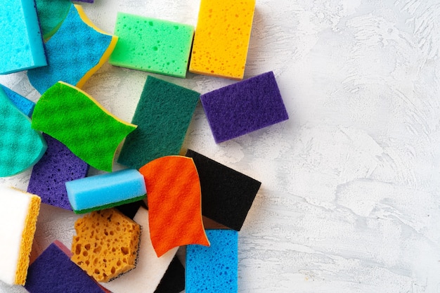 Pile of colorful cleaning sponges on gray background