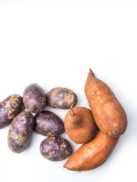 Pile of colorful fresh little potatoes over a white background