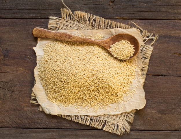 Pile of CousCous in a wooden spoon