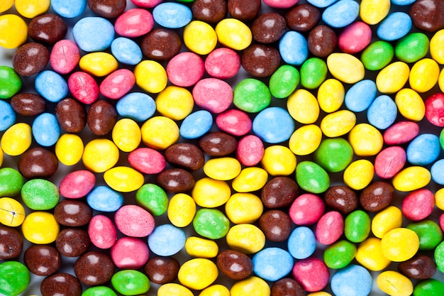 Pile of delicious rainbow colorful chocolate candies background