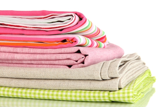 Pile of different fabrics isolated on white