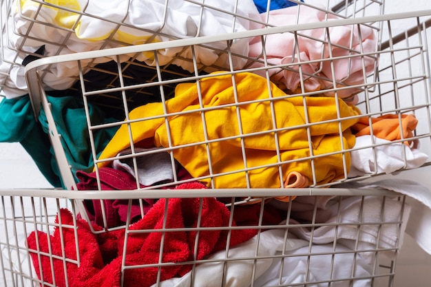 Pile of dirty colorful laundry in baskets