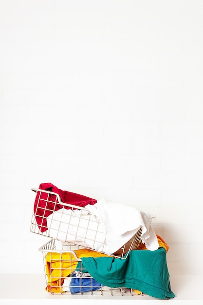 Pile of dirty colorful laundry in baskets