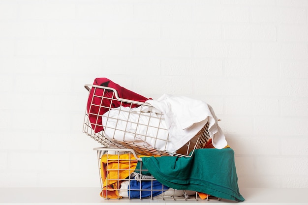 Pile of dirty colorful laundry in baskets