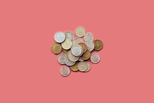 Pile of dirty russian rubles coins on pink background