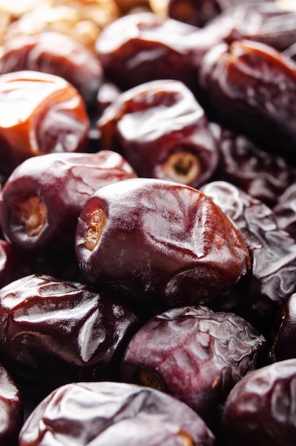 Pile of dried dates fruits on kitchen table Healthy nutritious antioxidant natural sweeteners