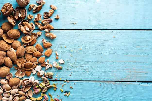 A pile of dried fruits organic pistachios almonds walnuts freshly harvested on a wood in a market