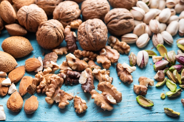 A pile of dried fruits organic pistachios almonds walnuts freshly harvested on a wood in a market