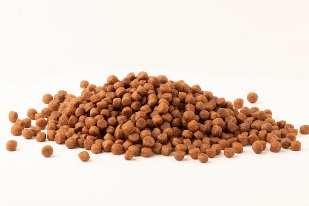 Pile of dry pet food isolated on white background