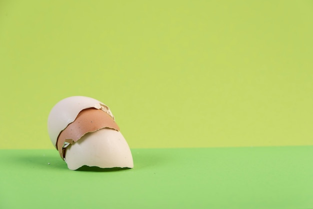 Pile of egg shells on green background