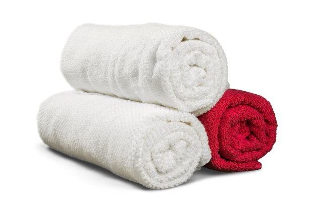 Pile of fluffy towels on light background