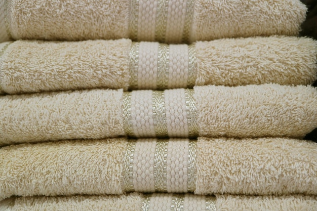 Pile of of folded off-white fluffy bath towels