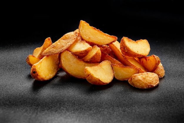 Pile of french fries over black background