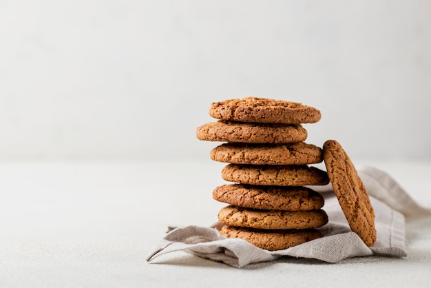 Pile of fresh baked cookies on cloth and white background