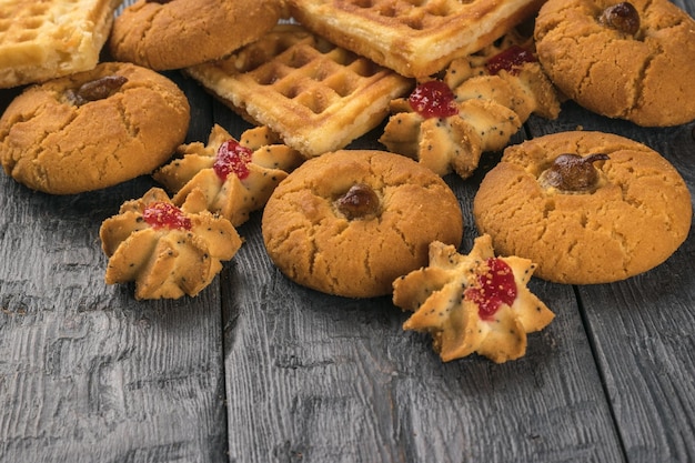 A pile of fresh cookies on a wooden table