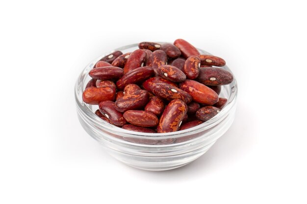 A pile of fresh raw red beans in a transparent bowl, isolated on a white background.