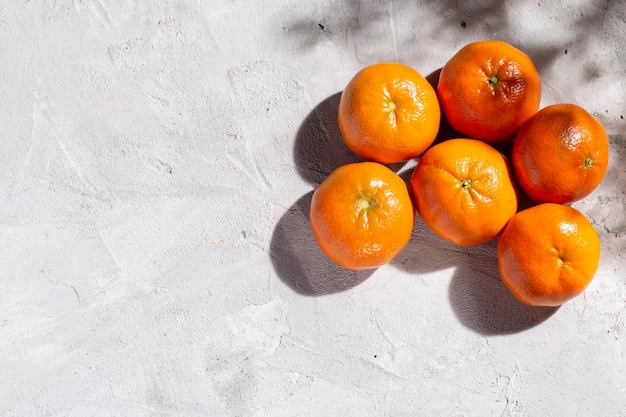 Pile of fresh tangerines on the concrete table