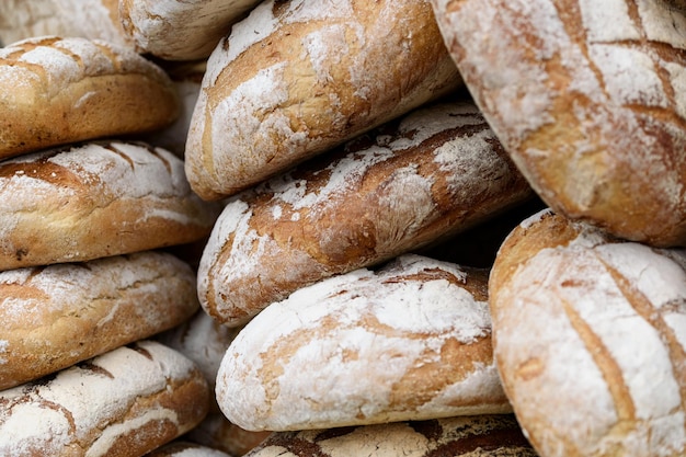 Pile of freshly baked wholemeal breads in the bakery or local farmer market