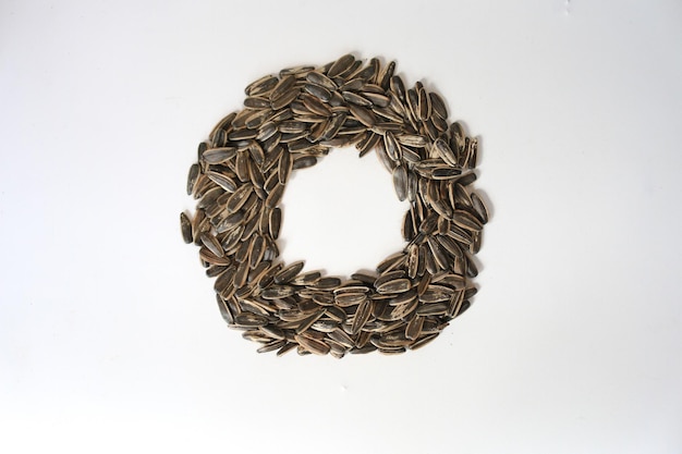 Pile of fried sunflower seeds with circle shape isolated on white background