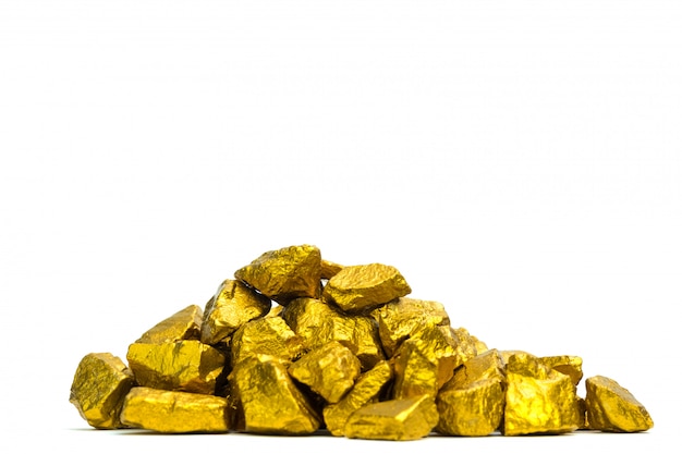 A pile of gold nuggets or gold ore on white