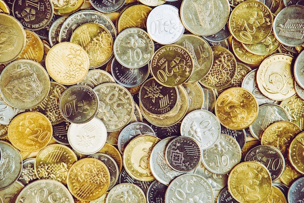 A pile of golden coins saving money business and financial concept selective focus