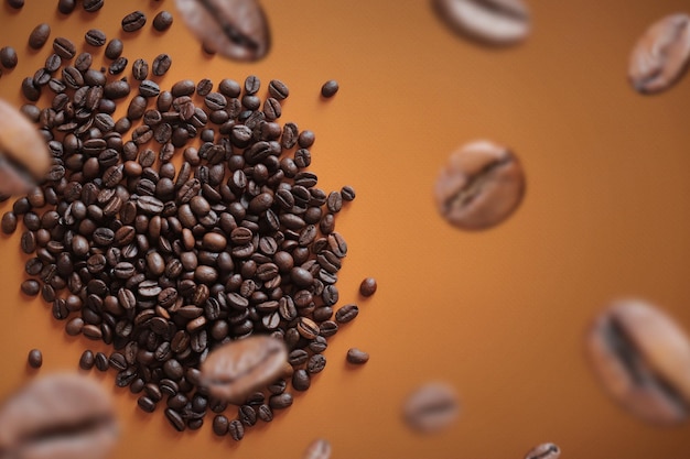 Pile of halves of dark brown coffee beans copy space Orange background