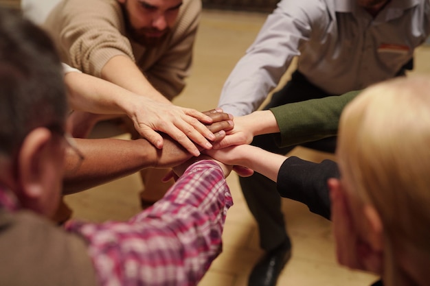 Photo pile of hands made up of several people of various ethnicities as symbol of unity