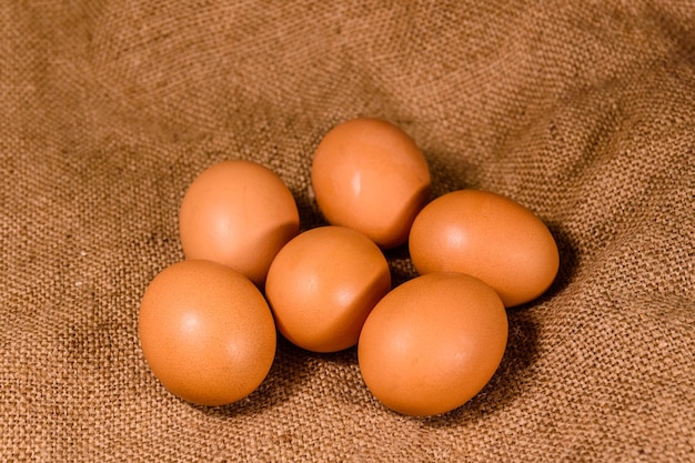 Pile of the hen eggs on sackcloth