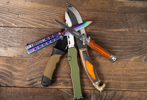 A pile of hunting knives on a table