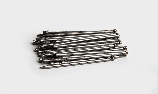 A pile of metal nails on a white isolated background Concept for construction